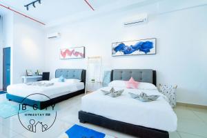 two beds in a room with white walls at Austin 18 IKEA - AEON in Johor Bahru