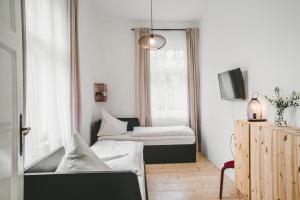 Habitación pequeña con 2 camas y TV. en Apartmány Natálie en Františkovy Lázně