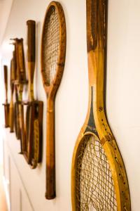 a rack of tennis rackets on a wall at Potters Toowoomba Hotel in Toowoomba