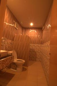 a bathroom with a toilet and a sink at The Palm Resort Kampeang Saen in Nakhon Pathom