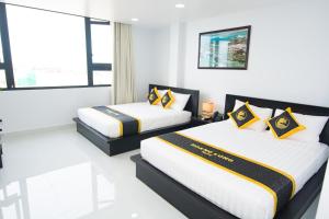 Postel nebo postele na pokoji v ubytování Hoang Long Hotel Phan Thiết