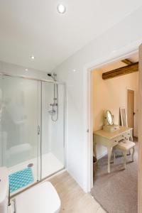 a bathroom with a shower and a desk at The Shippen in Great Chatwell