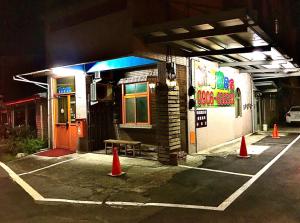 a parking lot in front of a restaurant at night at New Fox Guest House in Zhuangwei