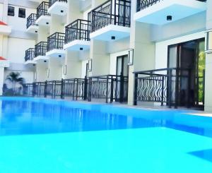 an empty swimming pool in front of a building at Costa Palawan Resort in Puerto Princesa City