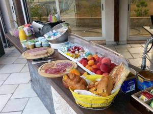 a counter with a bunch of different types of food at La Pinède D'Estarac in Bages