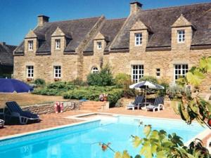 a large house with a swimming pool in front of it at Chambres d'hotes "Manoir Des Quatre Saisons" in La Turballe