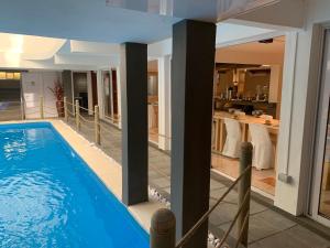 a large swimming pool in a house with a kitchen at Sikamifer Tourist Resort in Quatre Bornes