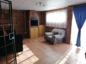 a living room with a couch and a window at BLS (Baie Lekker Slaap) in Bloemfontein