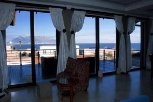 a living room with a chair and a view of the ocean at 4 Bedroom Luxury Home with View of the Ocean and Table Mountain in Cape Town