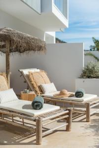 
a living room filled with furniture and a patio at The Olive - Boutique Apartment Hotel and Spa in Cala Llonga

