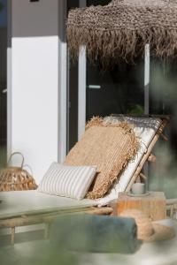 
a bed with a blanket on top of it next to a window at The Olive - Boutique Apartment Hotel and Spa in Cala Llonga
