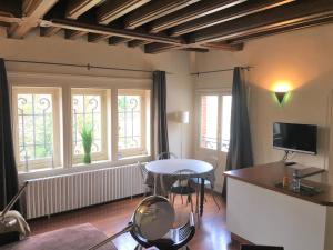 a living room with a table and some windows at Maunoury Citybreak in Chartres