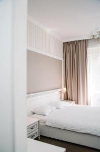 a bedroom with two beds and a mirror at Orly Park-Hotel in Kyiv