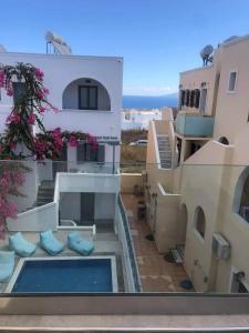 a view from the balcony of a building with a swimming pool at Antonia Hotel in Fira