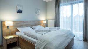 Posteľ alebo postele v izbe v ubytovaní Apartamenty Sun & Snow Resort Karkonosze