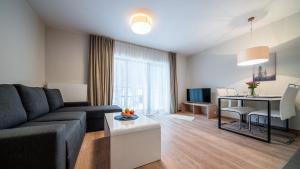 Televízia a/alebo spoločenská miestnosť v ubytovaní Apartamenty Sun & Snow Resort Karkonosze