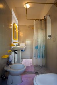 a bathroom with a sink and a toilet and a shower at Villa Ongaro in Lido di Jesolo