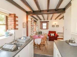 een keuken met een tafel en een eetkamer bij Stable Cottage in Colyton