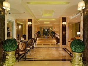 a lobby of a hotel with chairs and a staircase at Gulliver's Tavern Hotel in Bangkok