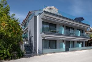 a white building with a spiral staircase on top of it at 4- you Family in Metamorfosi