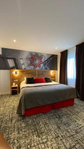 a bedroom with a large bed in a room at Logis - Le Christina in Bourges