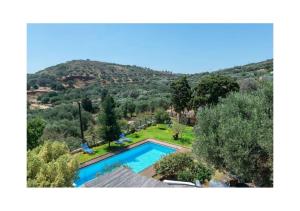 an aerial view of a swimming pool in a yard at Elounda Collection Villa in Vrouchas