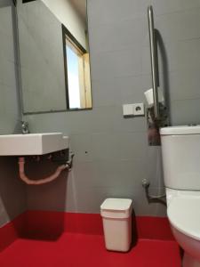 a bathroom with a toilet and a sink at Traveller Box Hostel in Seville