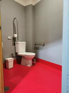 a bathroom with a toilet and a sink at Traveller Box Hostel in Seville