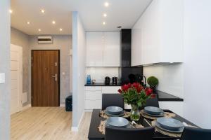 a kitchen and dining room with a table and chairs at Angel Apartments 1 in Krakow