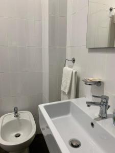 a white bathroom with a sink and a toilet at Hotel Ristorante Borgo Antico in Ceprano
