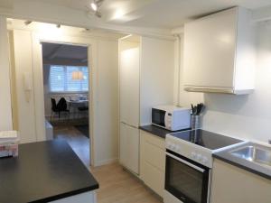 a kitchen with a sink and a microwave at Cozy apartment in vibrant Nørrebro in Copenhagen