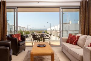 a living room with a couch and a table at Privilege Sea View Apartment Arte Nova - Fuzeta in Moncarapacho