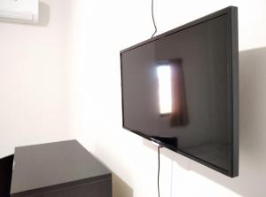a flat screen tv hanging on a wall at Wisma Anton Soedjarwo in Areman