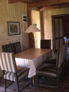 a dining room table and chairs with a wooden table at Naturpark Ferienhaus in Szalafő