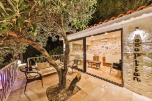 a house with a tree in the middle of a room at Hamarat Otel in Kaş
