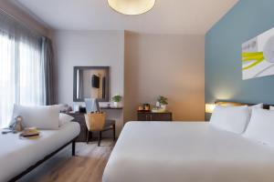 En eller flere senger på et rom på Hotel Argento