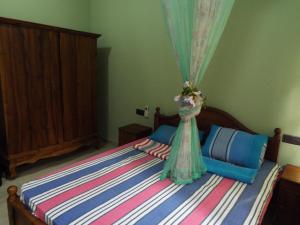 a bedroom with a bed with a dress on it at Ceylon Epic Inn in Bentota