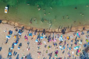an overhead view of a crowd of people on a beach at Hotel Argento in St. Julianʼs