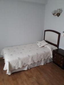 a bedroom with a bed and a dresser in a room at Hotel Aranda in Aranda de Duero