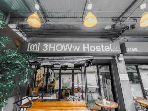 a restaurant with a sign on the front of it at 3Howw Hostel Khaosan in Bangkok