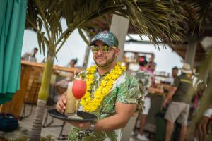 a man is holding a drink on a tray at Townhouse Boutique Hotel in Cartagena de Indias