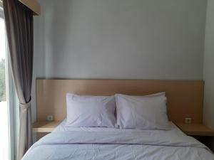 Postel nebo postele na pokoji v ubytování Mahakam24 Residence