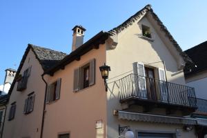 a building with a balcony and a window at La Ghirba in Santa Maria Maggiore