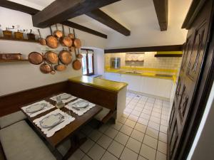 a kitchen with a table with plates on it at La Ghirba in Santa Maria Maggiore