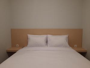 Postel nebo postele na pokoji v ubytování Mahakam24 Residence