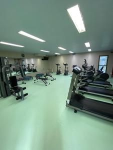 a gym with several treadmills and elliptical machines at Beach class muro alto in Porto De Galinhas