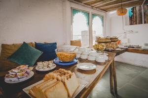 a table with sandwiches and other food on it at Udai Niwas - By The Lake in Udaipur