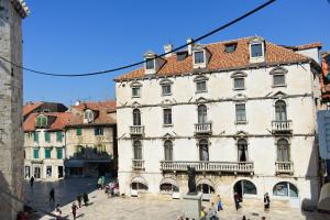 a large building with people walking in front of it at Hotel Kastel 1700 in Split