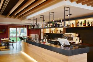 a bar in a restaurant with a counter at Nodo Hotel in Codroipo