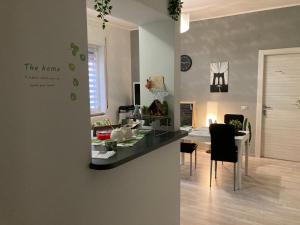 a kitchen and living room with a counter and a table at Family in Potenza